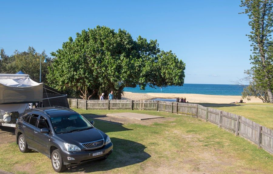A site with direct access to the beach, just over the fence from the sand and sea.